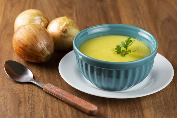 Bowl with onion soup and croutons on the table.
