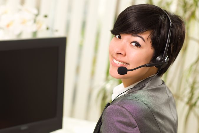 Young Woman Smiles Wearing Headset