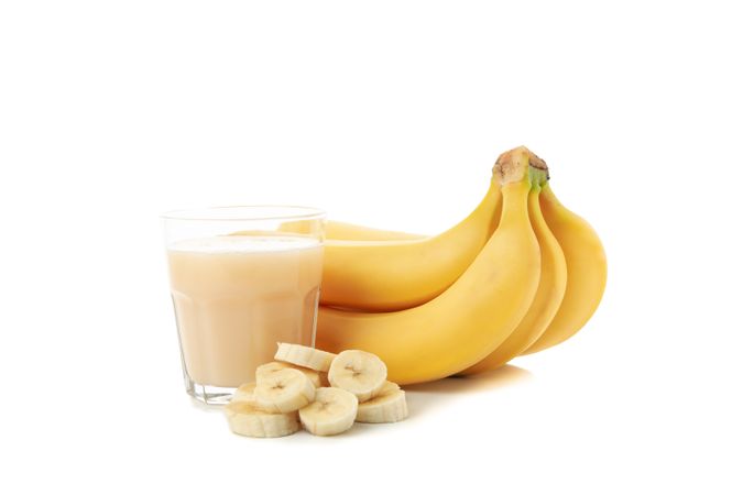 Banana juice isolated on studio background. Fresh fruit