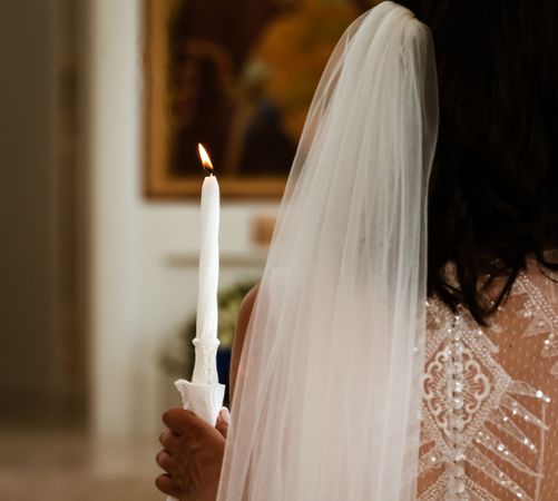 Delicate details of the wedding celebration. Newlyweds hold hands.