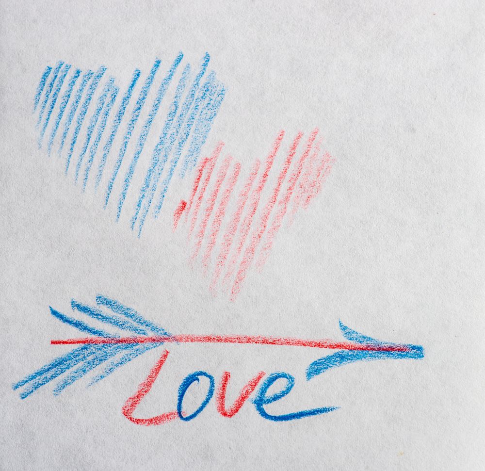 Valentine Day holiday card concept with hearts and the word "love" on paper