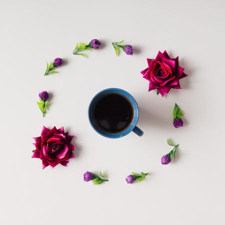 Flowers arranged in circle with coffee mug