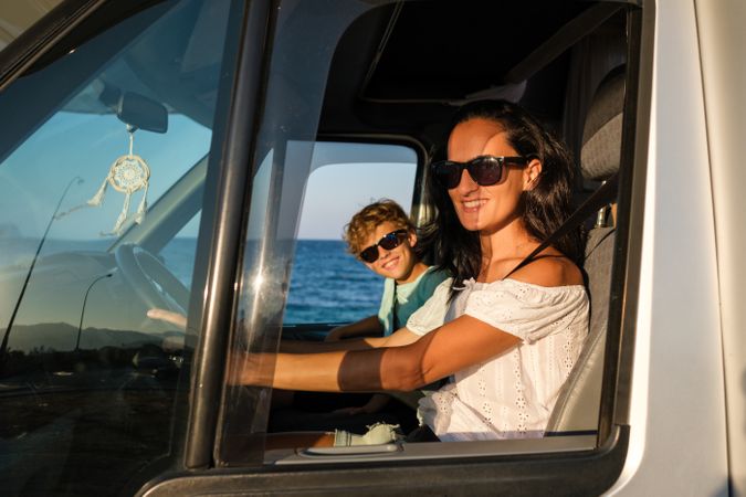 Mother and son traveling by car at seaside