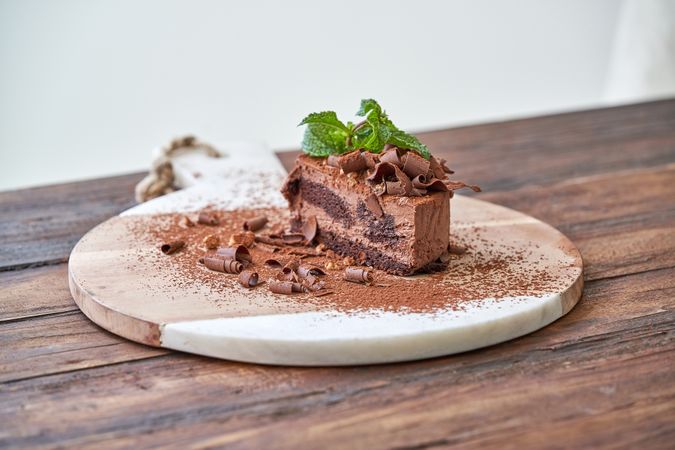 Delicious chocolate pastry on wooden board