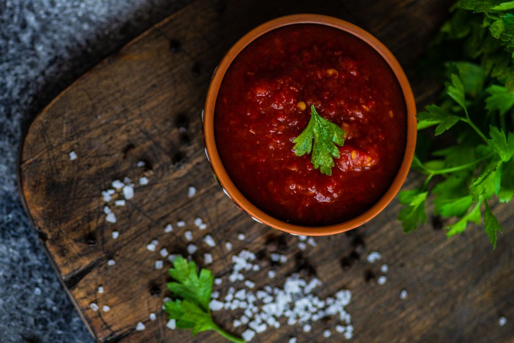 Top view of traditional Georgian sauce - satsebeli with parsley garnish