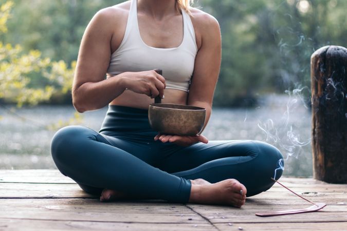 Young woman meditating and doing yoga in nature