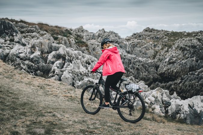 Female cyclist riding on mountain road