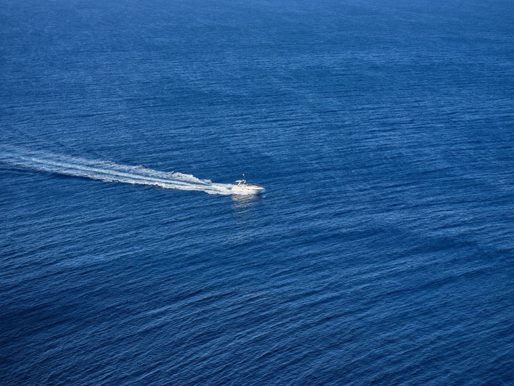 White yacht sailing in blue sea