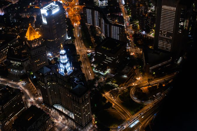 Top Down Aerial View of New York City Streets Lit with Neon Lights from Billboards. Busy Metropolis Traffic with Cars, Yellow Taxis, Commercial Vehicles and People Walking