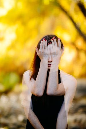 Double exposure shot of woman with hands covering eyes with eyes showing