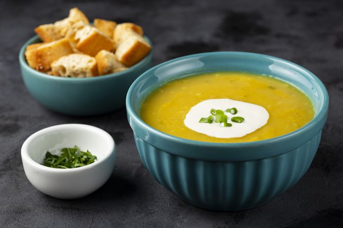 Bowl with pumpkin soup on the table.