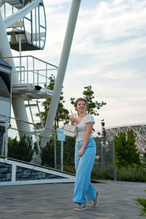 Woman near to ferris wheel