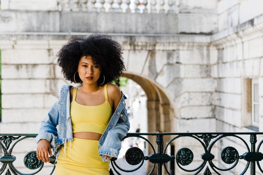 Stylish female leaning on railing outdoors