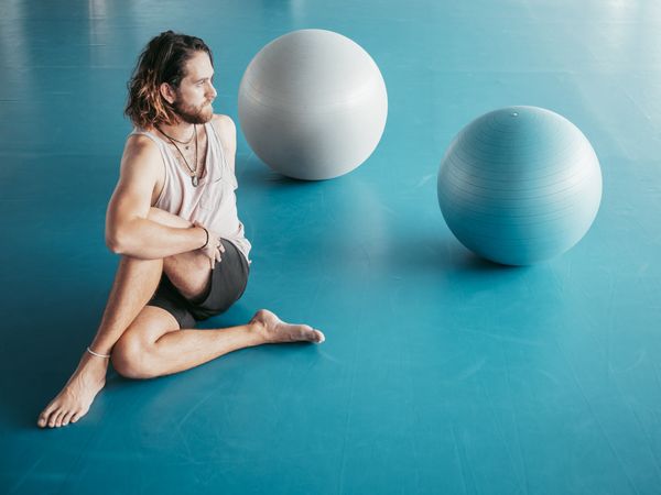 Male stretching in spacious room
