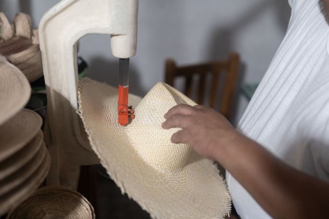 Making a hole in a natural fiber hat