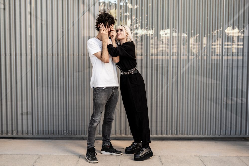 Couple near stripped modern building