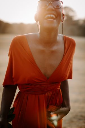 Woman in orange dress laughing