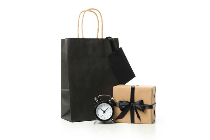Paper bag, alarm clock and gift box isolated on blank background