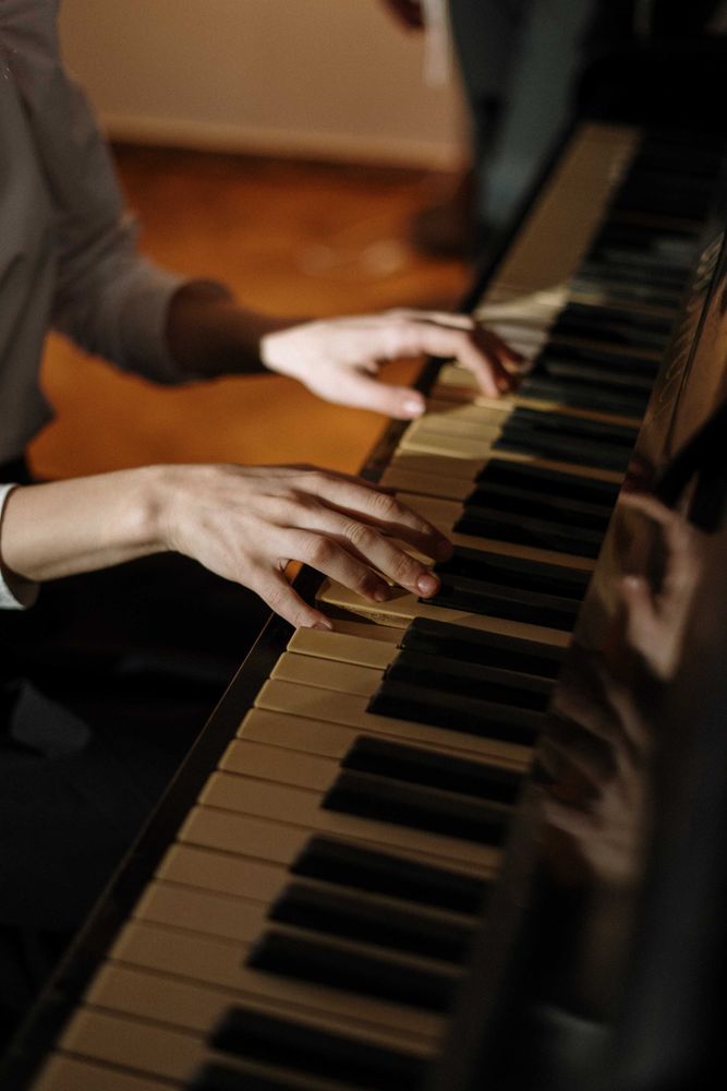 Cropped image of person playing the piano