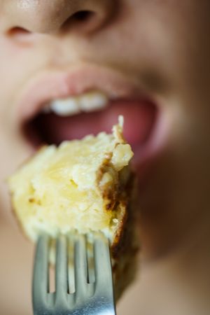 Close up of girl biting into frittata