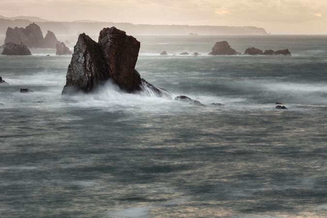 Storm with blustering waves on rocky coast
