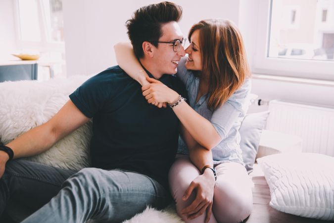 Young man and woman playfully embrace