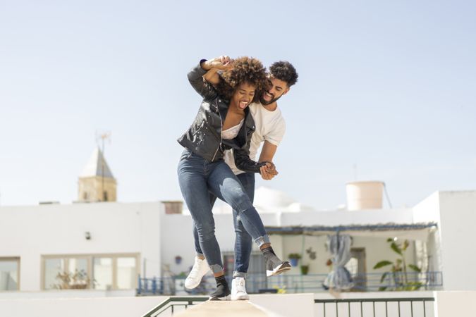Young couple having fun on street