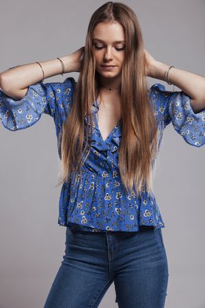 woman with floral shirt posing in studio