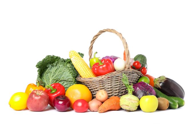Wicker basket and different vegetables isolated on blank background