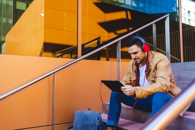 Man using tablet on steps