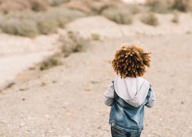 curly toddler on nature
