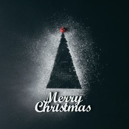 Christmas tree with sugar snow on dark background