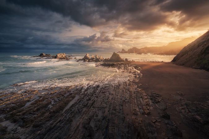 Picturesque seaside with rocks at bright sunset