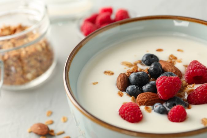 Flat lay composition with parfaits dessert and ingredients on cement background