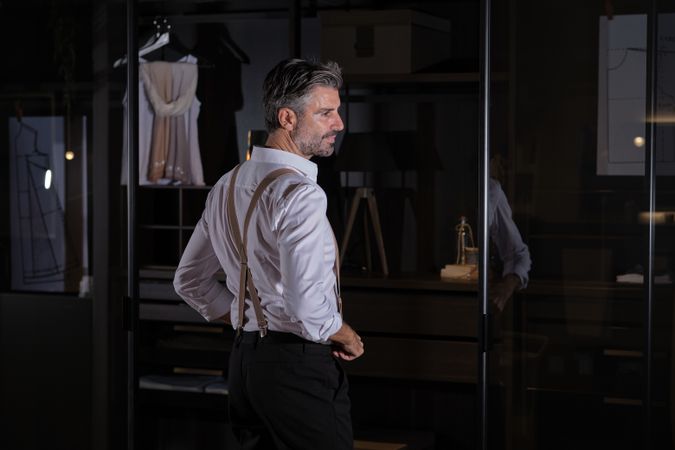 Man standing near glass door