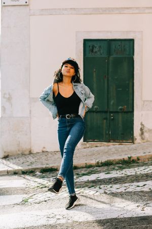Happy female walking on crosswalk