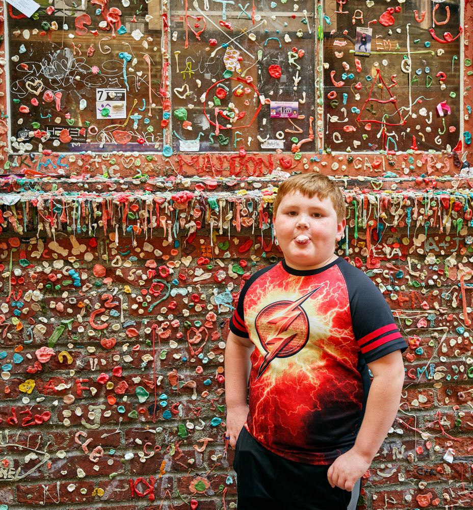 Six-year-old Gregorio Drozco III at the gum wall next to the Market Theatre, Seattle, Washington
