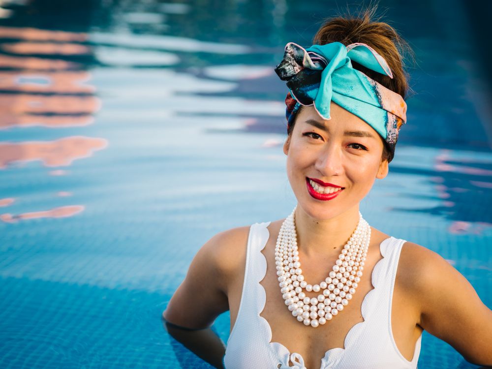 Young elegant Chinese woman relaxing inside a pool
