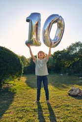 Happy boy with balloon number 10
