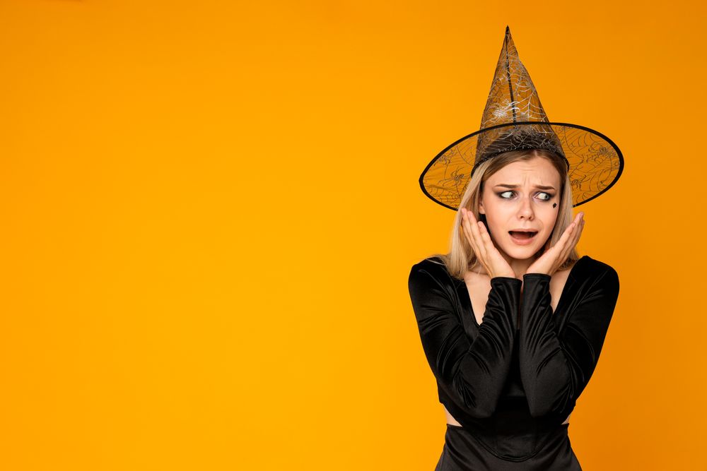 A woman in a Halloween costume is very terrified