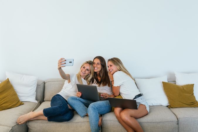 Woman taking a selfie with her sisters