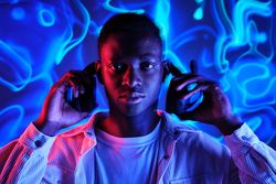 Serious Black man taking on wireless headset