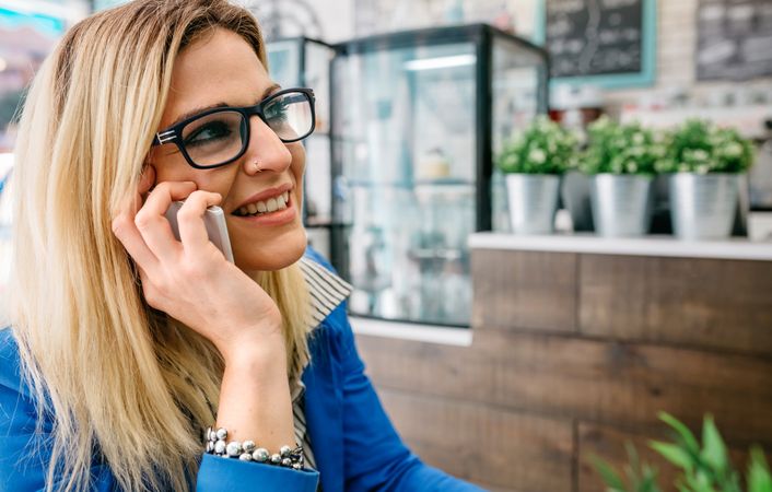 Woman talking on phone in a cafe