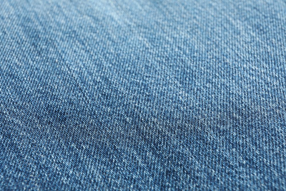 Texture of blue jeans as background, space for text