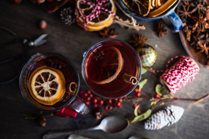 Top view of dried orange slices and cinnamon sticks in warm drinks