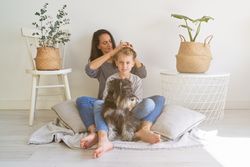 Mother doing hairstyle to son