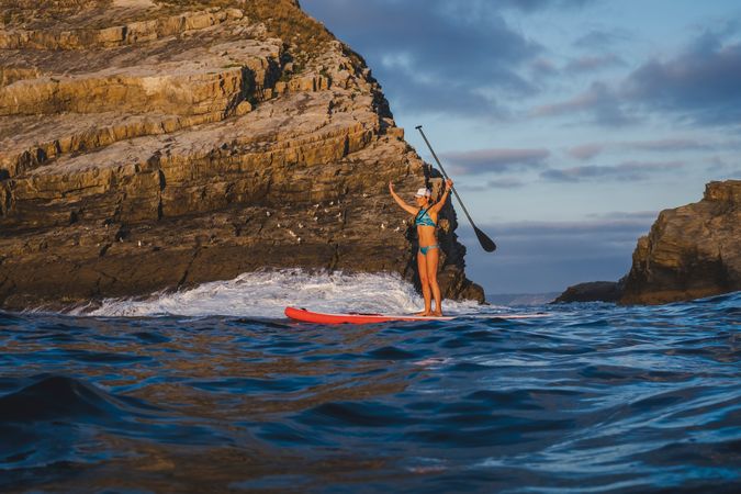 Woman on paddleboard floating in sea
