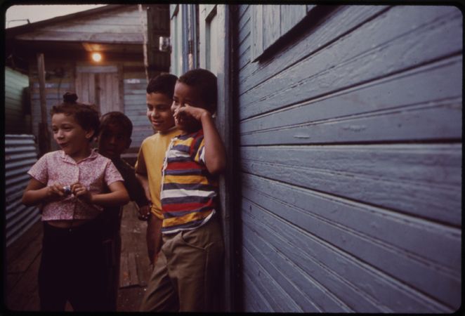 Group of young Puerto Rican children outside their home