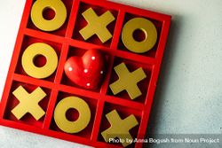 St. Valentine day card concept with red dotted heart in center of tic-tac-toe game beXodl