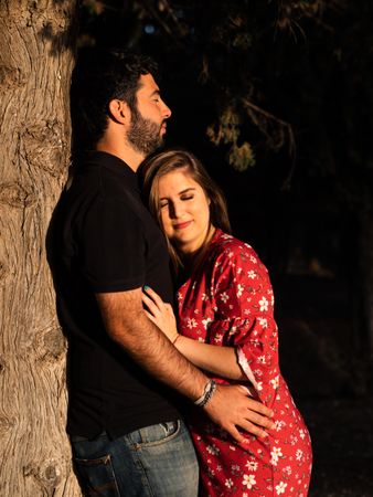 Young happy couple embracing in beautiful garden